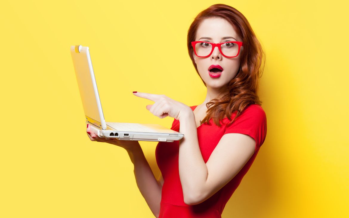 Girl with a laptop on a yellow background