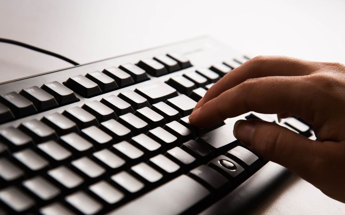 Human hand typing on the keyboard